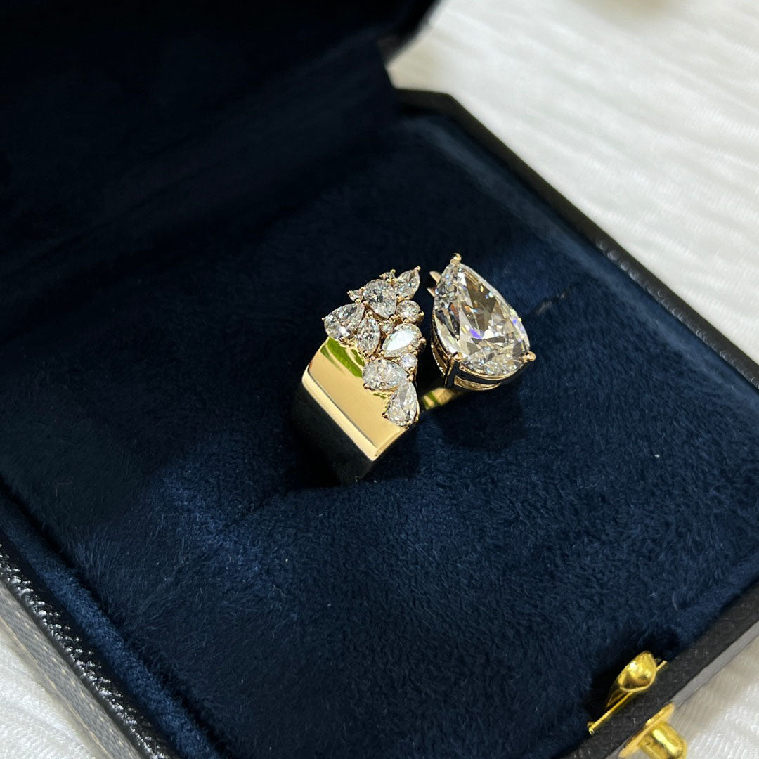 3.03-carat lab diamond as the center stone | accompanied by pear-shaped, marquise, and round small diamonds | set on an ultra-wide band | surrounded by pavé-set small diamonds | spectacular and luxurious | 18k gold
