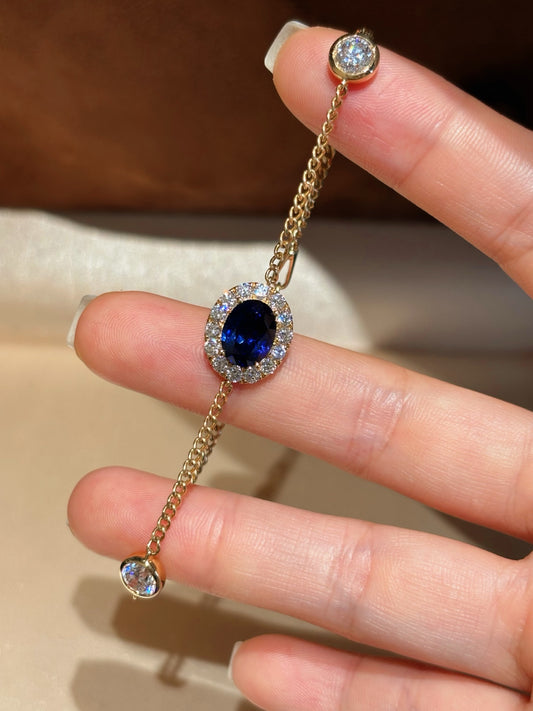 Oval Lab Royal Blue Sapphire Bracelet with Diamond Halo & Bezel Round Accents | 18K Yellow Gold