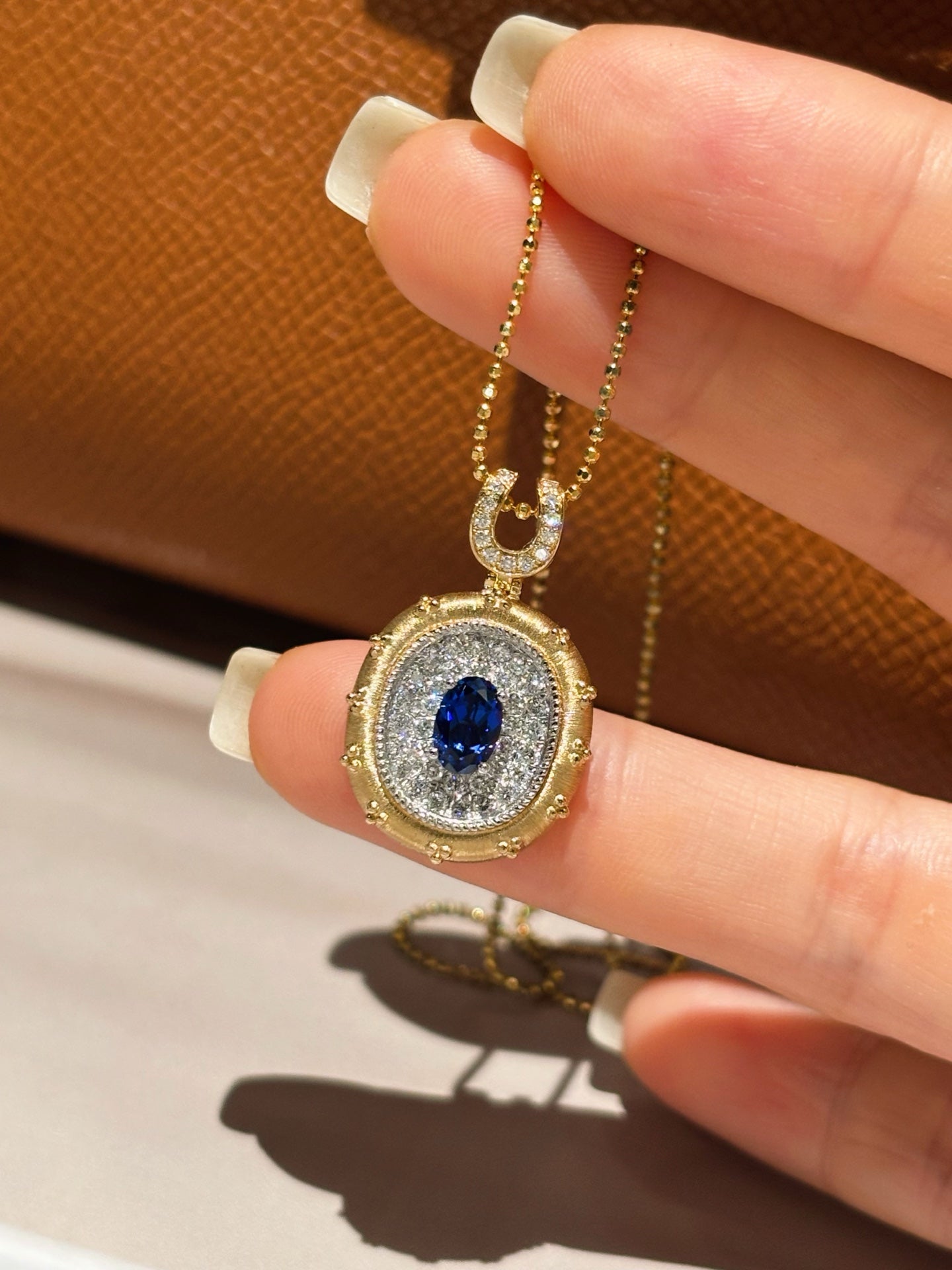 Two-Tone Solid Gold Oval Lab Grown Royal Blue Sapphire Pavé Diamond Horseshoe Motif Locket Pendant Necklace | 18K Gold