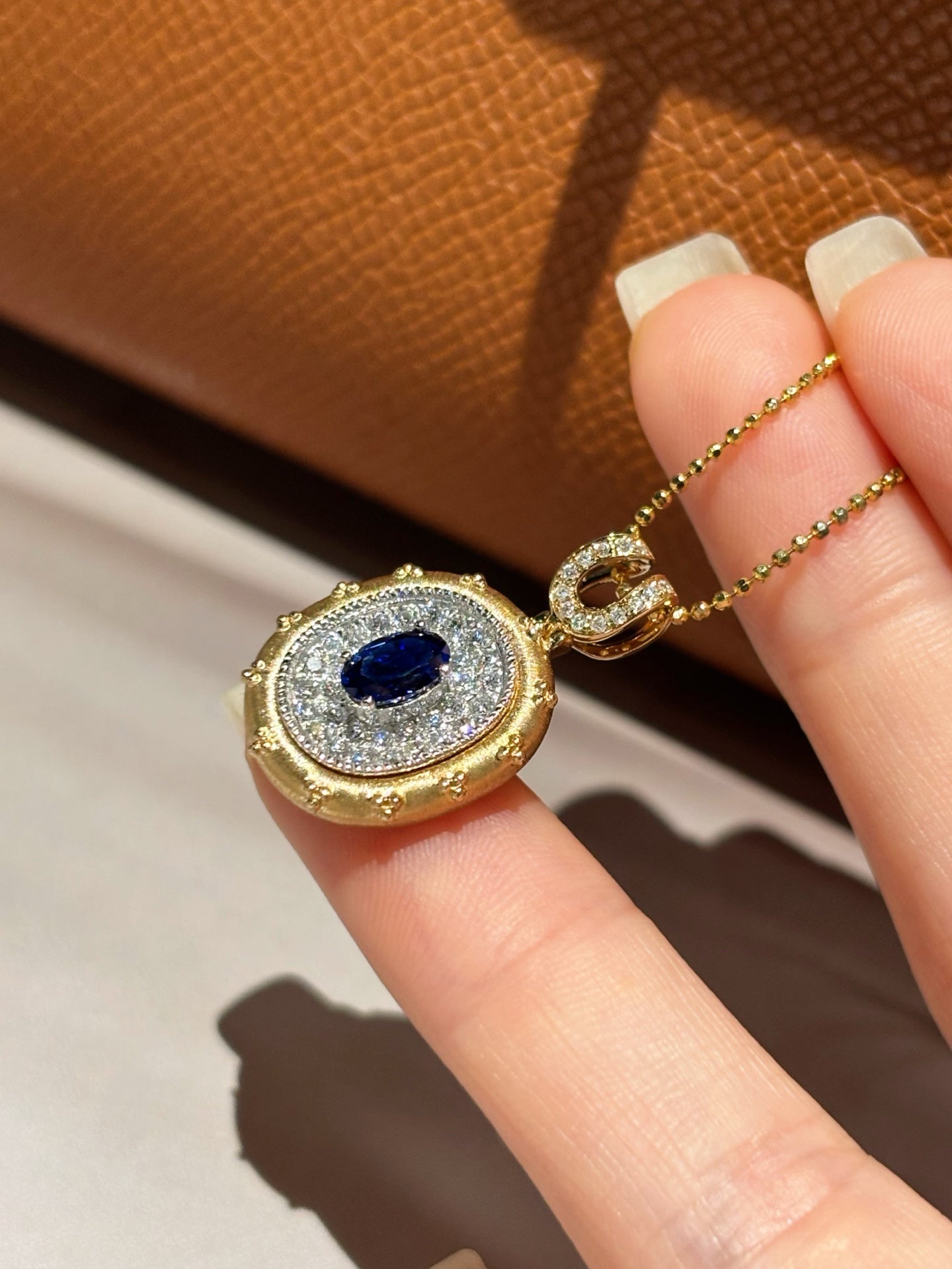 Two-Tone Solid Gold Oval Lab Grown Royal Blue Sapphire Pavé Diamond Horseshoe Motif Locket Pendant Necklace | 18K Gold